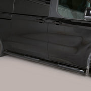 A black side view of a minivan with black running boards installed along the side, photographed against a neutral light gray studio background.